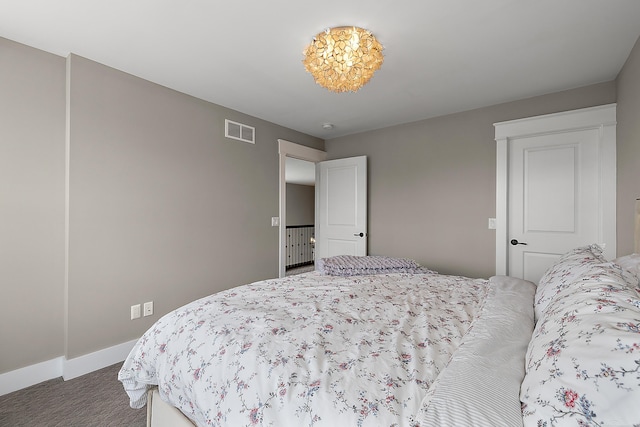 bedroom with baseboards, visible vents, and carpet flooring