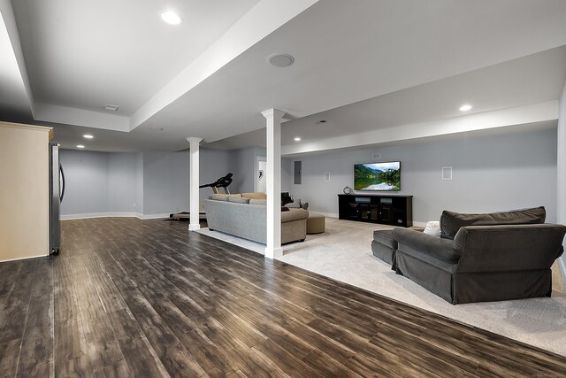 living room featuring baseboards, dark wood-type flooring, and recessed lighting