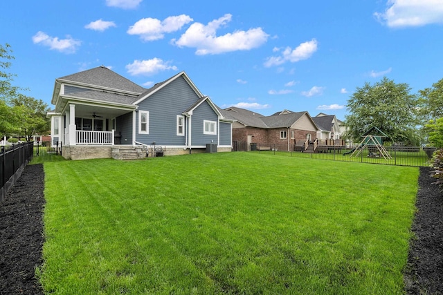 rear view of property with a lawn, a fenced backyard, and ceiling fan