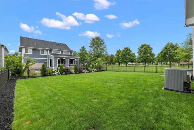view of yard featuring a fenced backyard and central AC unit