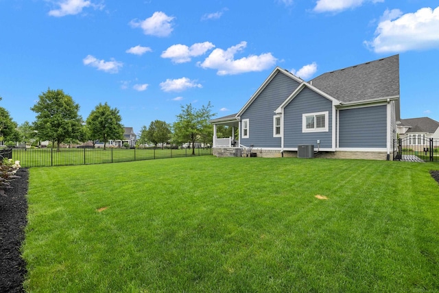 back of house with a lawn, cooling unit, and a fenced backyard
