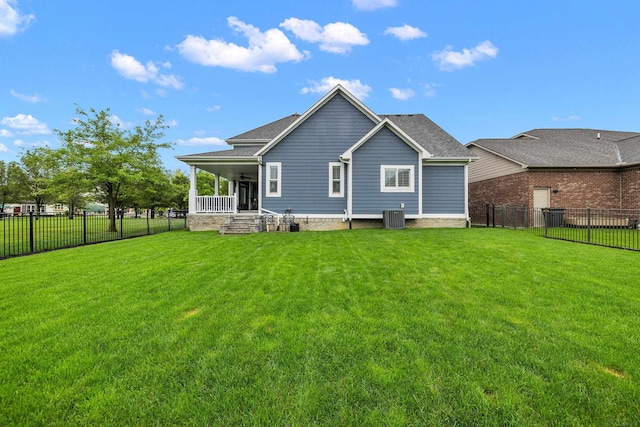 back of property with a lawn, a porch, a fenced backyard, and central AC unit