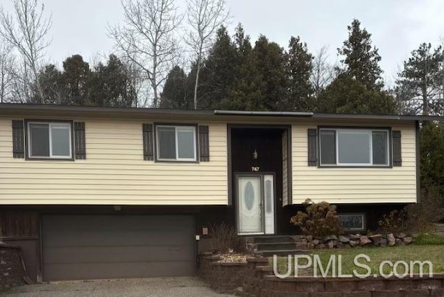 bi-level home featuring driveway and a garage