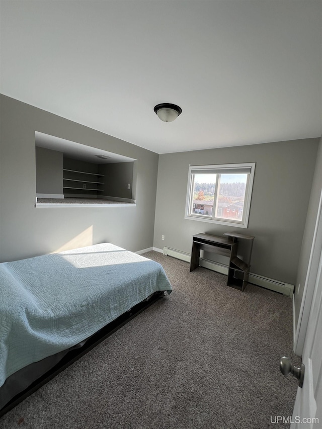 carpeted bedroom with a baseboard heating unit and baseboards