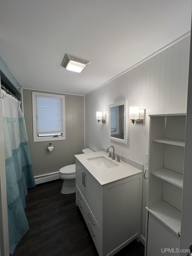 full bath with baseboard heating, wood finished floors, vanity, toilet, and visible vents