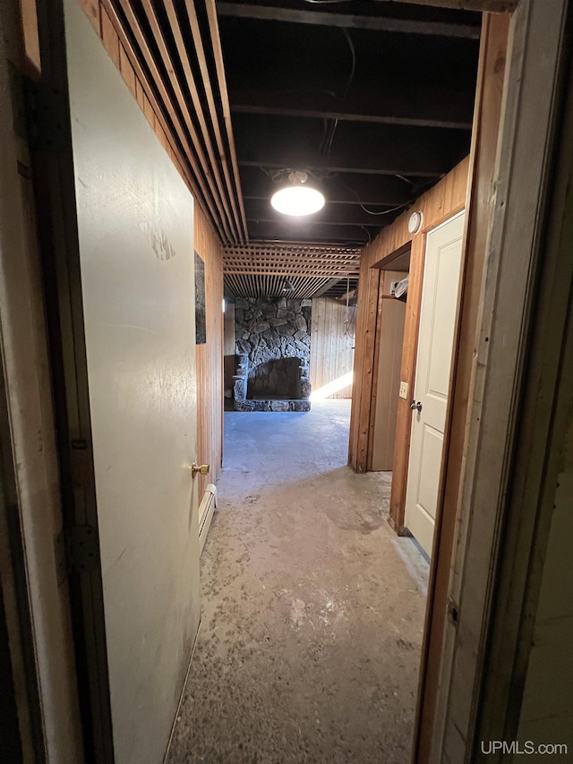 hallway with concrete floors and a baseboard radiator