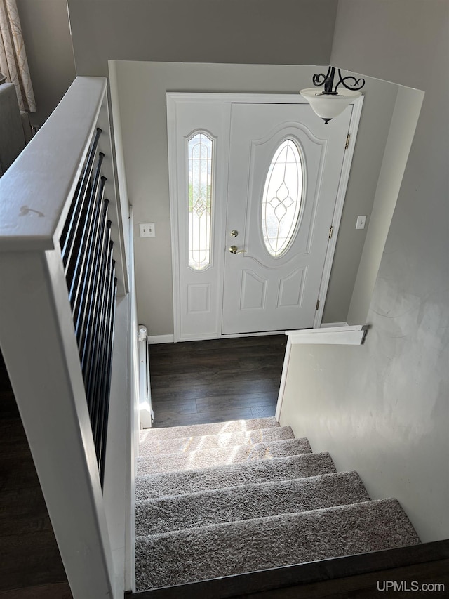 entryway with wood finished floors and stairway
