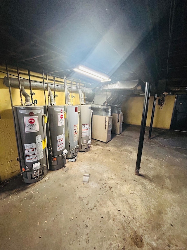unfinished below grade area featuring heating unit and gas water heater