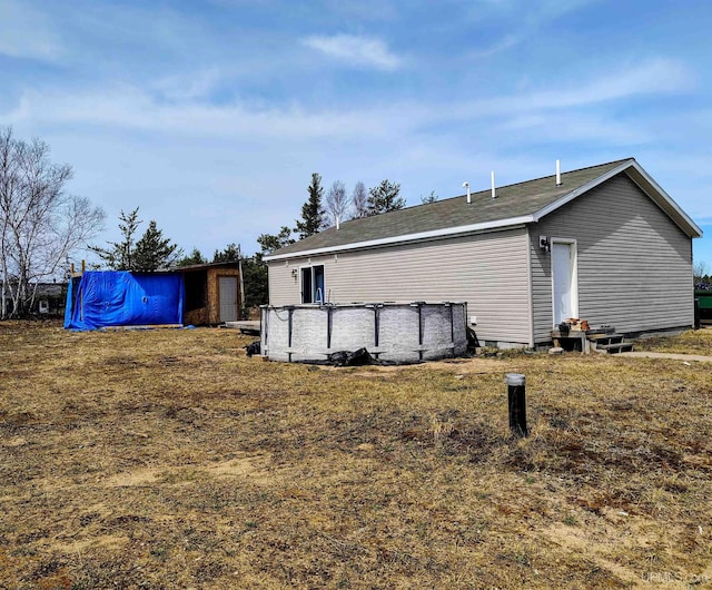 view of side of property with an outdoor pool