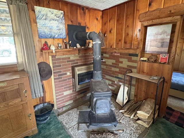 room details with a wood stove, heating unit, and wood walls