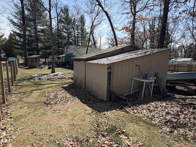 view of shed featuring fence