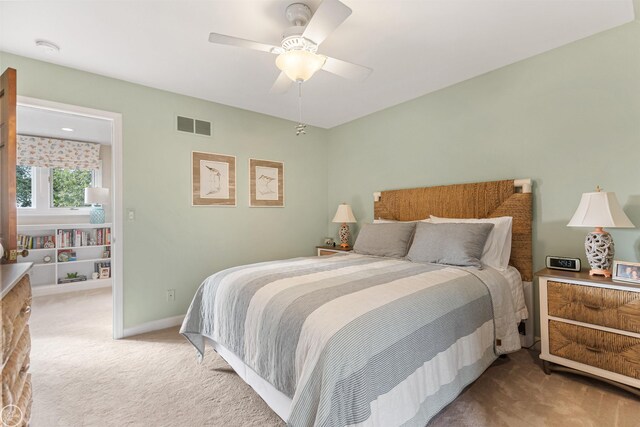 carpeted bedroom with baseboards, visible vents, and ceiling fan