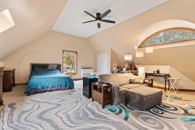 bedroom with lofted ceiling, ceiling fan, carpet flooring, and a closet
