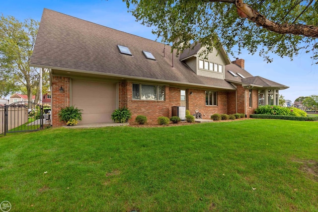 view of front of property with a chimney, brick siding, a gate, and a front lawn