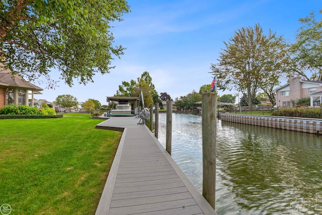 view of dock featuring a water view and a yard
