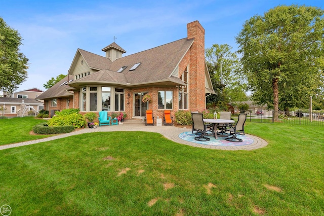 back of property featuring a yard, brick siding, fence, entry steps, and a patio area