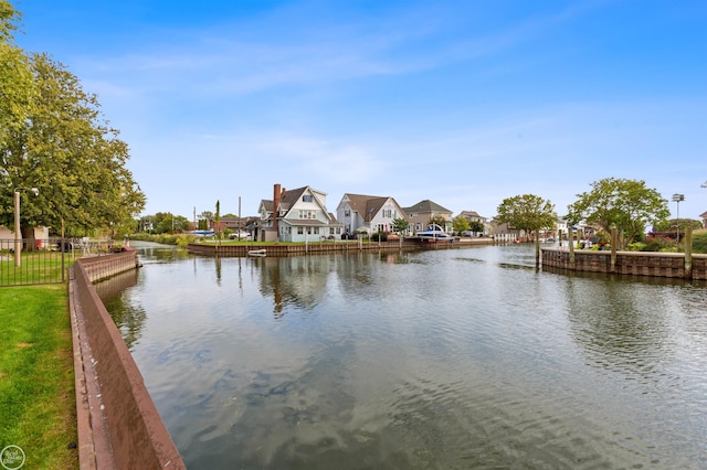 property view of water with fence and a residential view
