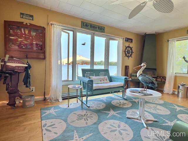 living area with ceiling fan and wood finished floors