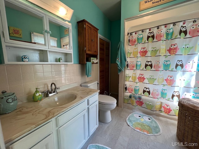 full bathroom with vanity, toilet, and backsplash