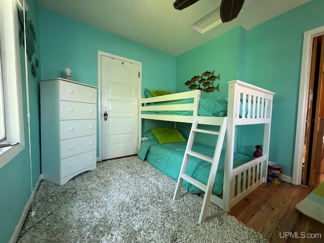 bedroom with wood finished floors and baseboards