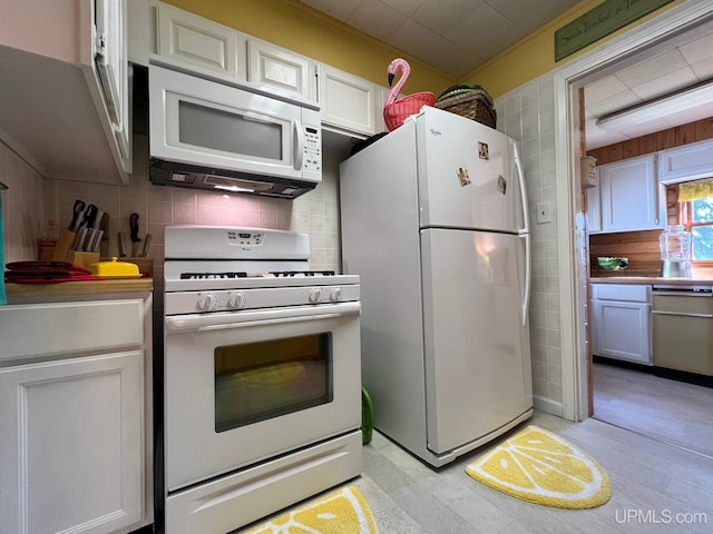 kitchen featuring white cabinetry, white appliances, and backsplash