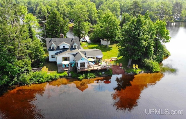 drone / aerial view with a water view and a view of trees