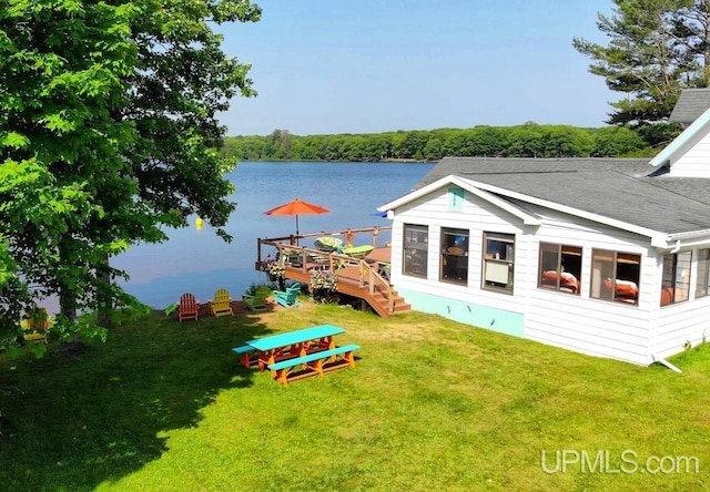 dock area with a deck with water view and a yard