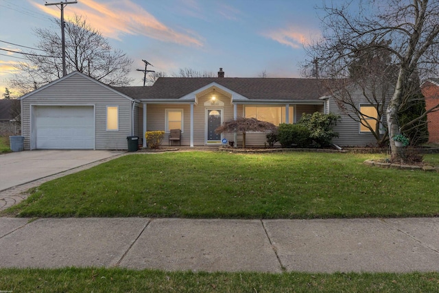 ranch-style home with driveway, a chimney, a shingled roof, a yard, and a garage
