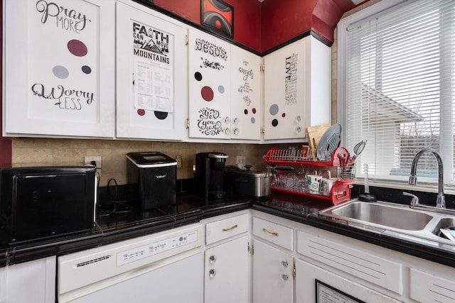 kitchen with a sink, backsplash, white cabinetry, dark countertops, and dishwasher