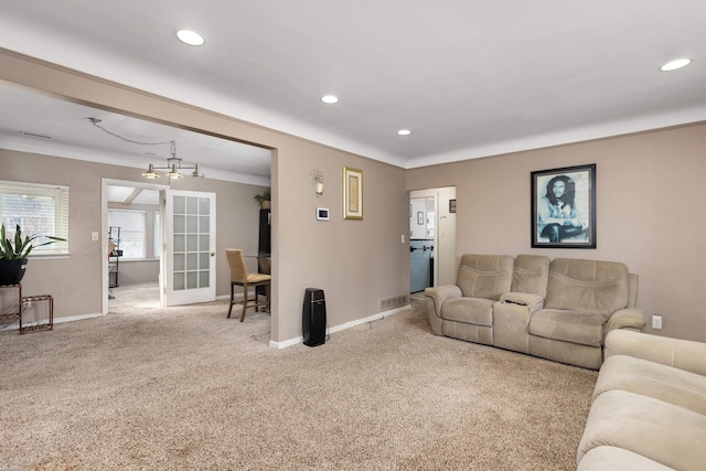 carpeted living area featuring visible vents, recessed lighting, crown molding, and baseboards