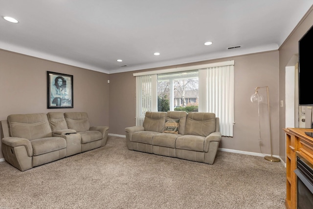 carpeted living area featuring baseboards, visible vents, ornamental molding, and recessed lighting