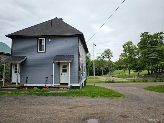 view of front of house featuring roof with shingles