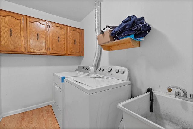 17769 Edloytom Way Unit 253, Clinton Township, MI 48038 - laundry room featuring separate washer and dryer, cabinet space, light wood-type flooring, and baseboards