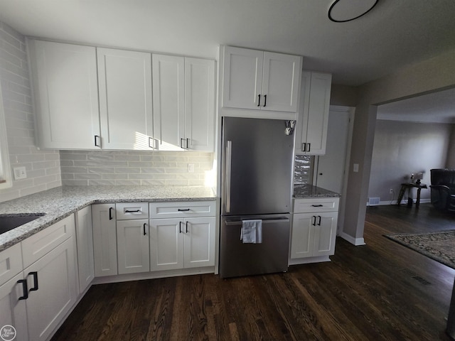 35734 Weideman St, Clinton Township, MI 48035 - kitchen featuring freestanding refrigerator, dark wood-type flooring, white cabinets, and light stone counters