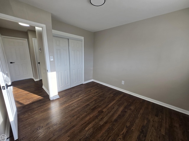 35734 Weideman St, Clinton Township, MI 48035 - unfurnished bedroom with baseboards, dark wood-style floors, and a closet