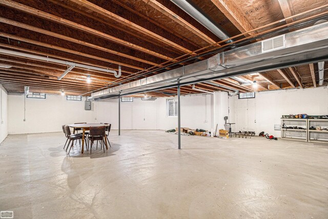 unfinished below grade area with visible vents and electric panel