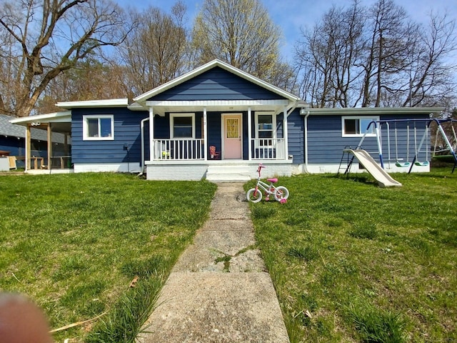 view of front facade featuring a front lawn, a playground, and covered porch