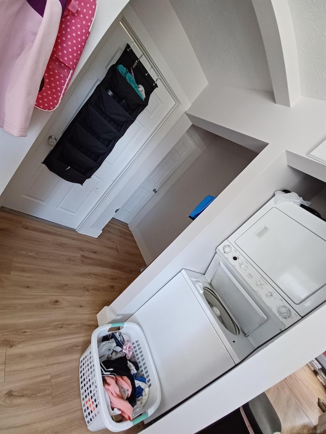 washroom with wood finished floors and laundry area