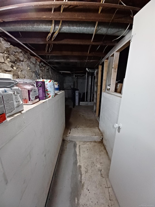 unfinished basement featuring water heater