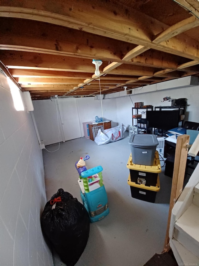 unfinished below grade area with concrete block wall