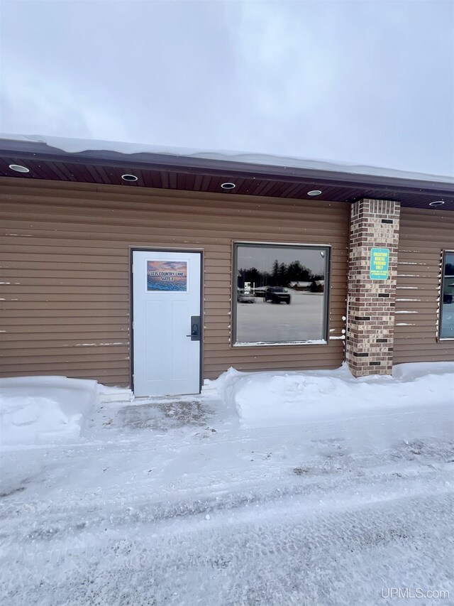 view of snow covered property entrance