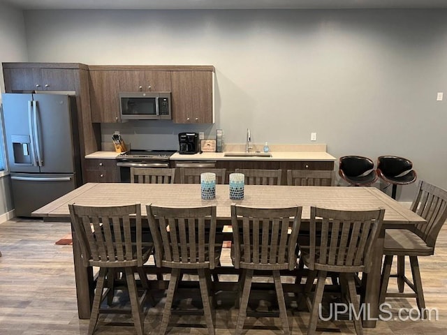 dining area with light wood-style flooring