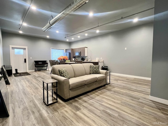 bedroom featuring recessed lighting, light wood-style flooring, and baseboards