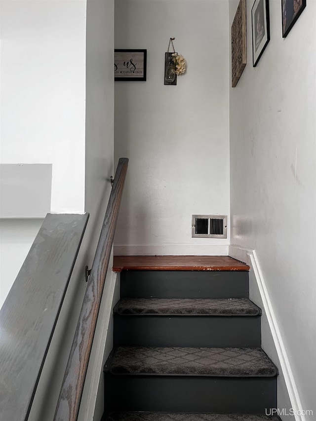 staircase featuring visible vents