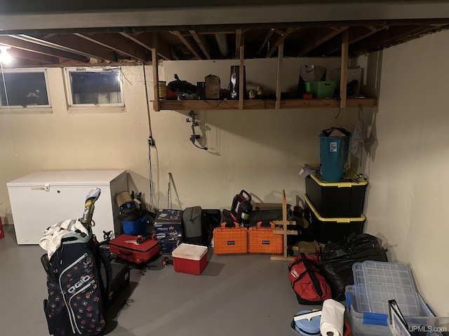 unfinished below grade area with white refrigerator