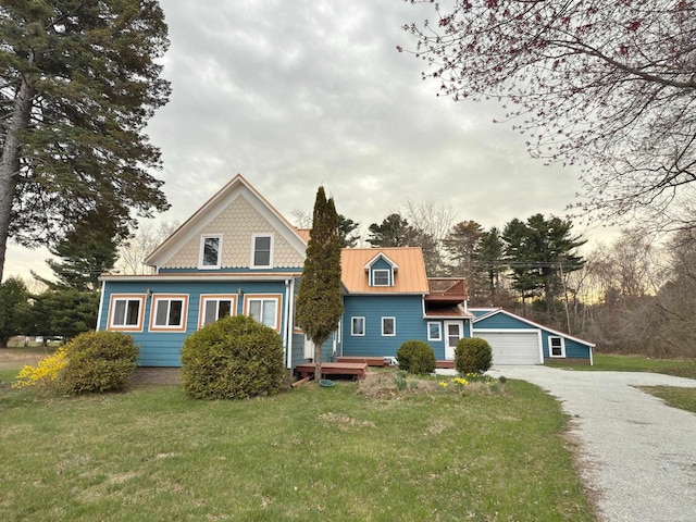 4358 Lakeshore Rd, Lexington, MI 48450 - view of front of house with a deck, metal roof, an outbuilding, a front yard, and a garage