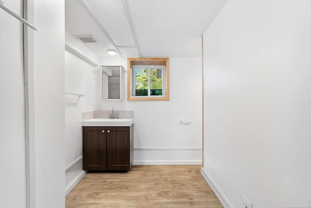 4358 Lakeshore Rd, Lexington, MI 48450 - bathroom featuring baseboards, visible vents, wood finished floors, and vanity