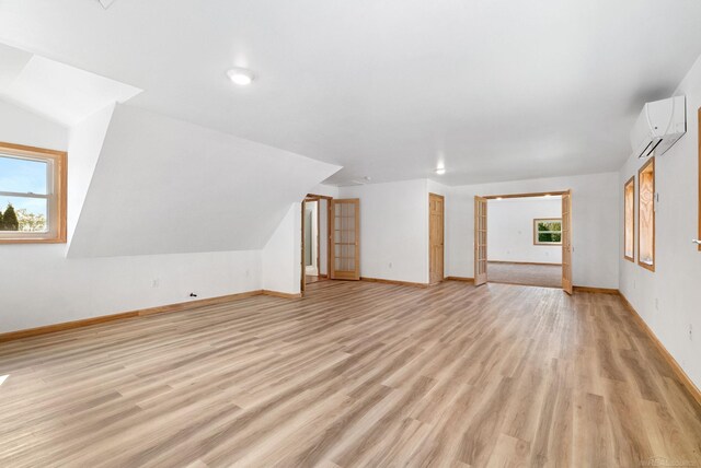 4358 Lakeshore Rd, Lexington, MI 48450 - bonus room featuring baseboards, a wall mounted air conditioner, and light wood-type flooring