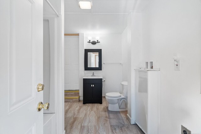 4358 Lakeshore Rd, Lexington, MI 48450 - bathroom with toilet, vanity, and wood finished floors