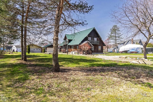view of front of property with metal roof, a front lawn, a garage, and a residential view